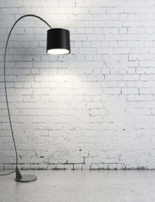 turned on black torchiere lamp