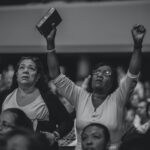 grayscale photography of people worshiping