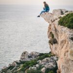 woman sitting on mountain