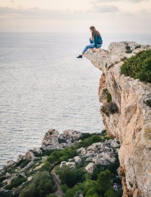 woman sitting on mountain