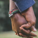 close up photo of two person s holding hands