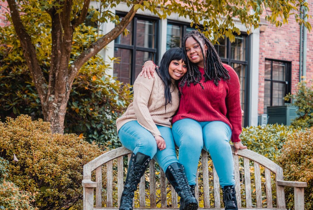 african american ladies sitting on top of wooden bench