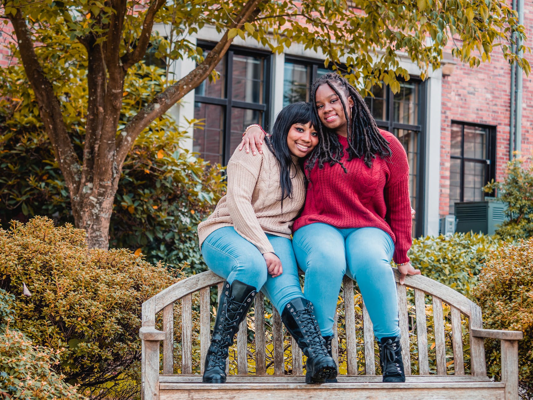 african american ladies sitting on top of wooden bench